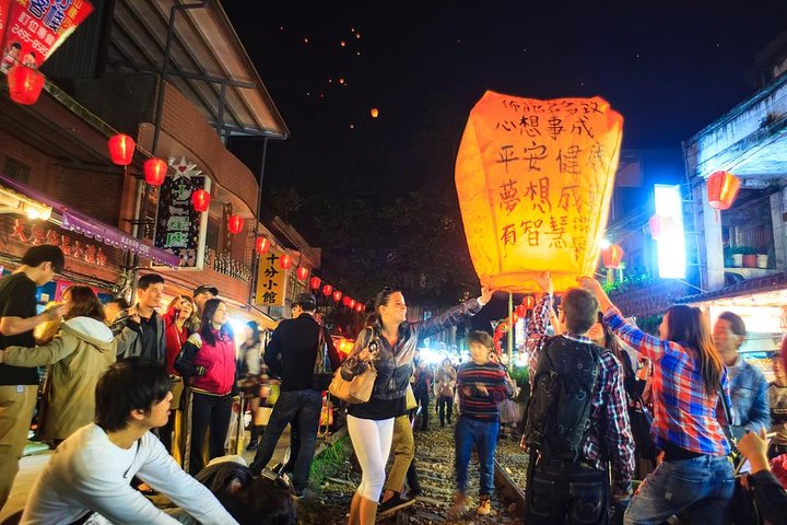Experience the charm of Taiwan as you release your own sky lantern in a bustling night market surrounded by stunning scenery and the warmth of local culture.