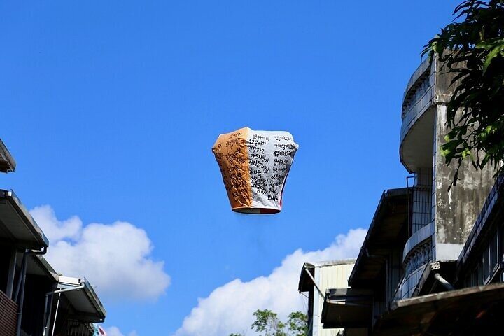 Experience the charm of Jiufen and Shifen as colorful lanterns soar against a brilliant sky creating an unforgettable backdrop for your journey through Taiwan's scenic treasures.
