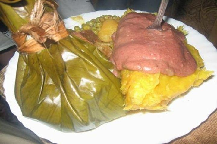 Meat/chicken/groundnuts cooked in banana leaves commonly known as luwombo with matooke, Irish potatoes and peas.