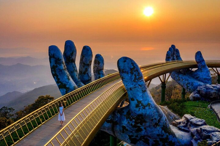Experience the stunning Golden Bridge embraced by giant hands as you stroll amidst breathtaking views of Da Nang and create unforgettable memories in Ba Na Hills.