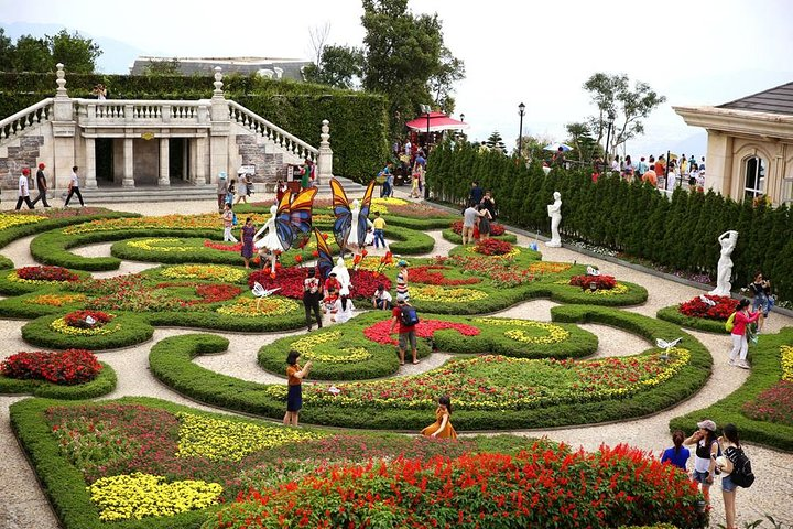 Stroll through beautifully manicured gardens where colorful blooms and playful sculptures create a delightful backdrop for family fun and unforgettable moments at Ba Na Hills.