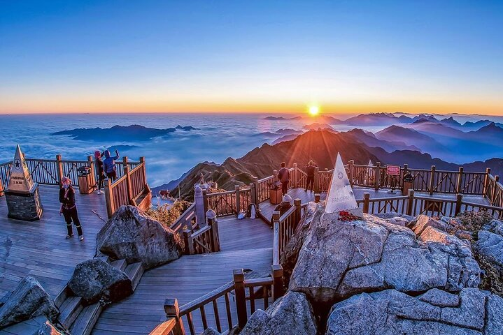 Experience breathtaking sunrises from Fansipan Mountain where majestic peaks rise above the clouds creating unforgettable memories during your Sapa adventure. Perfect for exploring and connecting with nature.