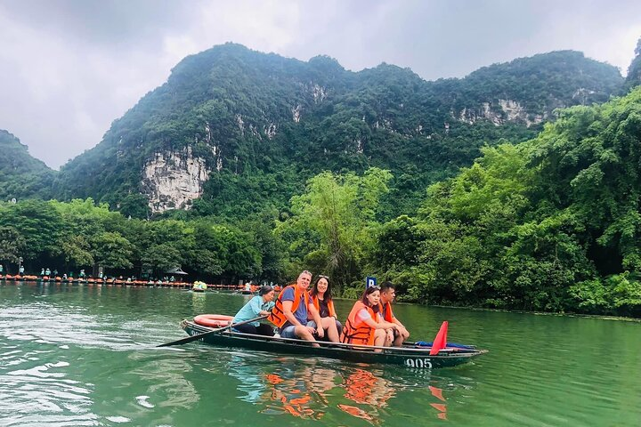 seating on the boat to see the caves and the moutain around