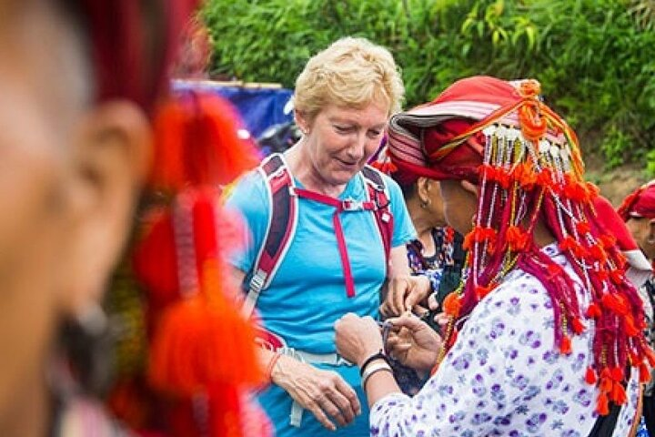 Experience the rich cultural exchange in Sapa as you connect with local Red Dao artisans showcasing their traditions amidst stunning mountain scenery and welcoming village life.