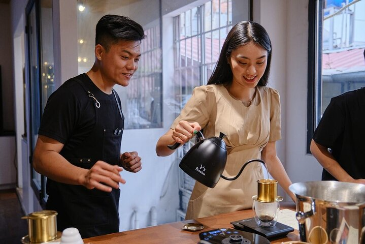 Experience the joy of crafting traditional Vietnamese coffees while savoring local 'bánh mì' surrounded by skilled instructors and fellow coffee lovers in the heart of Hồ Chí Minh City.