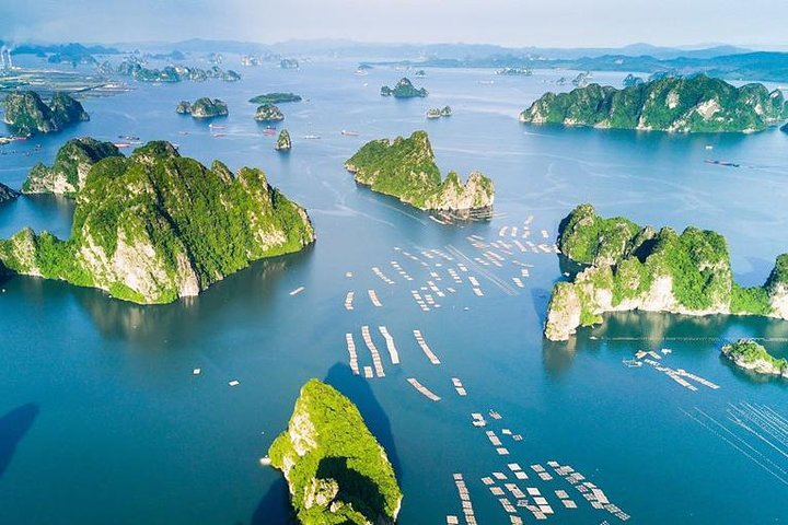 Explore stunning islets and unique rock formations while cruising through serene waters enjoying a delightful lunch and breathtaking views on a memorable boat adventure in Halong Bay.