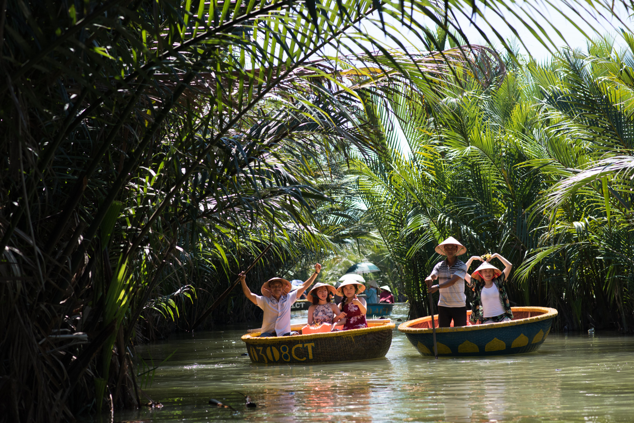 Navigate serene waterways in traditional basket boats surrounded by lush greenery. Experience the charm of rural life as you explore the coconut village near Hoi An.