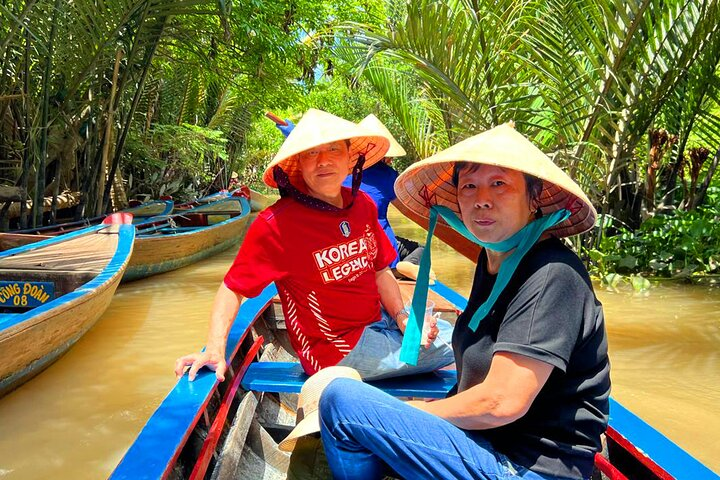 Experience the serene beauty of the Mekong Delta as you glide through lush waterways absorbing the charm of palm-lined shores and the warm smiles of local boaters.