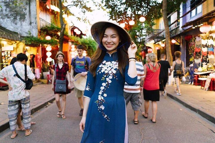 Wearing an Ao Dai in Hoi An adds a unique charm to exploring its bustling streets perfect for memorable photos amidst the rich cultural heritage and stunning scenery.