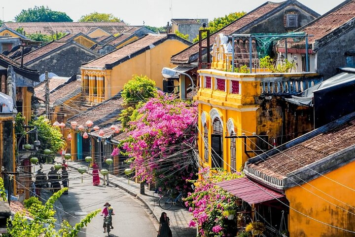 Wander through the charming streets of Hoi An where colorful buildings and blooming flowers create picturesque scenes offering an unforgettable glimpse of Vietnam's rich heritage and beauty.