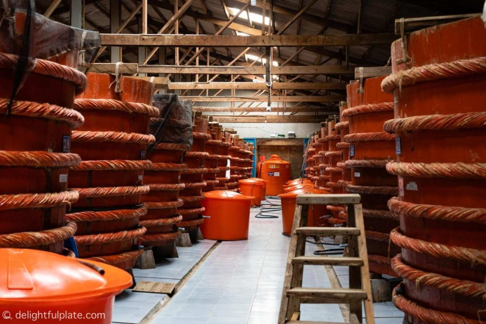 Explore the unique process of fish sauce production surrounded by traditional barrels that showcase the craftsmanship behind this beloved culinary staple. Experience the essence of Phu Quoc's local culture.