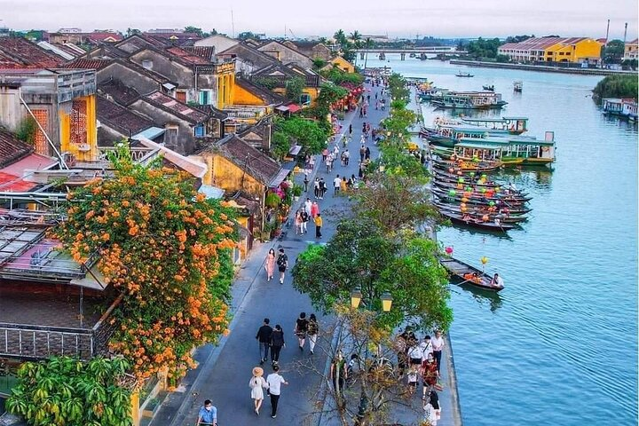 Explore the charm of Hoi An as you stroll along the river flanked by historic buildings and lively market stalls perfect for a memorable evening experience.